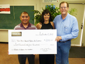 From left, Thad Lopez, Tracy Moore and Clyde Roberds at the presentation of a $2.500 check in donations from TECO team members to Moore's nonprofit Highline Hero Foundation. 