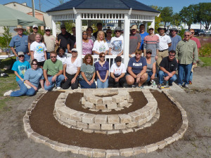 The team poses with the terrace it built, soon to be filled with flowers. 