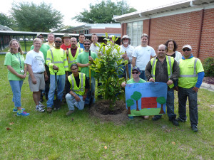 The tree-planting group at Temple Terrace Elementary with a sign in front of thanks from students at the school.