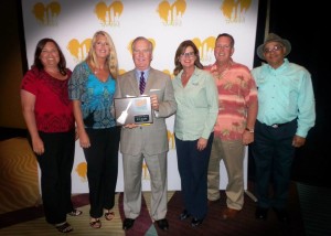 Tampa Mayor Bob Buckhorn presents Tampa Electric with a plaque in recognition of its status as a 2014 Paint Your Heart Out Silver Sponsor. From left to right: Lisa Grant, Stacy Hallman, Mayor Buckhorn, Bonnie Begley, Mike Begley and Candido Corona.