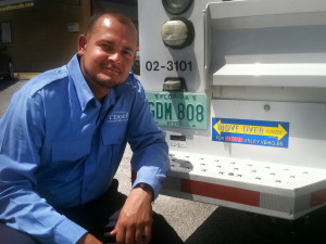 Chris Furlow at his truck with its "Move Over Florida" bumper sticker. 