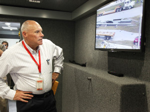 Bill Whale, senior vice president of Electric & Gas Delivery, watches a screen inside the vehicle that displays the image from the high-definition camera atop the vehicle's 56-foot-high mast. This enables emergency crews to analyze a crisis scene, including downed power lines after an emergency, from a safe distance.