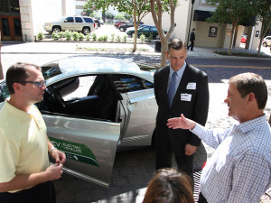 From left to right, Kenneth Hernandez, Tech Sgt. Erik Chenault and Keith Gruetzmacher discuss the benefits of the Cadillac ELR.