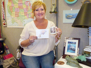 Rhonda Thompson with her prizes from the Manatee Viewing Center.