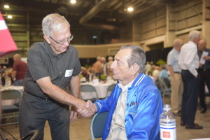 A legend at TECO, Heywood Turner, seated, greets Retiree Rendezvous guests like Harold Sabin. Turner's memoir about a lifetime in Tampa and at his company - "The Luckiest Guy Who Ever Walked the Face of the Earth" - was published last year. 