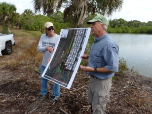 Tom Ries, right, details plans for the upcoming Phase III of the Newman Branch Creek restoration project. He and Stan Kroh are standing on the mulched remains of highly invasive Brazilian pepper, in an area that volunteers will fill with native species of plants better suited to the natural habitat.