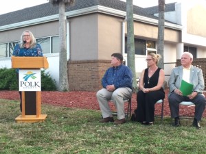 With Cindy Price, at teh podium, are, from left: Mike Seney, with AREA Real Estate Appraisers; Jane Thomas, with Doors2Change; and Polk County Commissioner Ed Smith.
