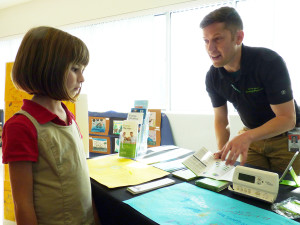 Ian Sprawls works to persuade a young Mega Night attendee that Energy Planner is ideal for her home.