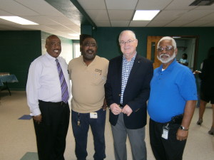From left, at Trinity Cafe: Hillsborough County Commissioner Thomas Scott; Robert Connelly, meter mechanic with Tampa Electric's Meter Services team; Mike Crouch, chairmen of the Elders at the 1st Church of God; and Marion Fleming, material specialist with Meter Services with Tampa Electric.