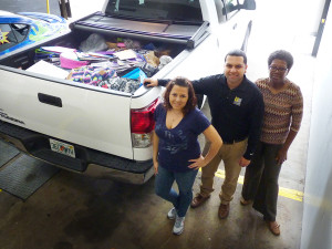 Brandi Scott, Will Carrera and Gerri Drummond with a truck loaded with donated school supplies for Metropolitan Ministries.
