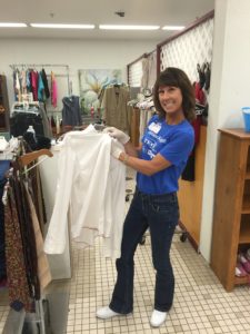 Stephanie Sarro helps organize items for the clothing store at Metropolitan Ministries' Tampa Heights campus.
