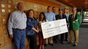 At the check presentation lunch to Shriners Children's Hospital are Paul Lofton, Kathy Hocking, Betsy Diaz, Chip Whitworth, Scott Cannon, Adam Parke and two Shriners representatives.
